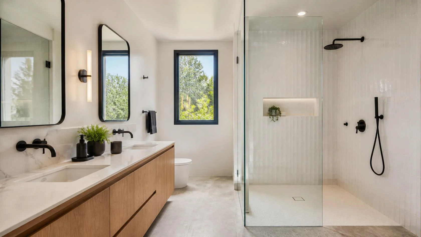 Remodeled San Jose bathroom with large-format porcelain floor tile, white vertical shower wall tile, frameless glass shower, and matte black fixtures.